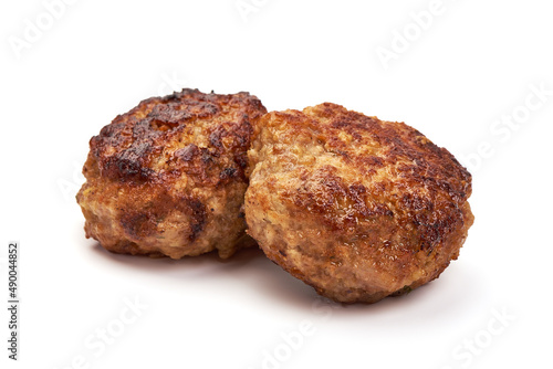 Roasted meatballs with spices, isolated on white background.