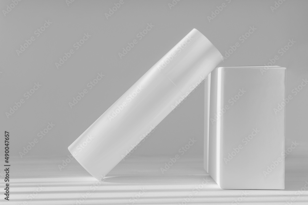 Mock-up of an aerosol can with foam for washing on white background, in rays of sunlight. Concept of empty bottles without labeling for cosmetics. Hygiene, disinfection Mock-up of an aerosol can with foam for washing on white background, in rays of sunlight. Concept of empty bottles without labeling for cosmetics. Hygiene, disinfection