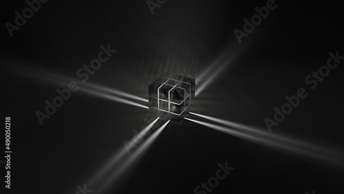 A black rubic (with light in it) on a black floor