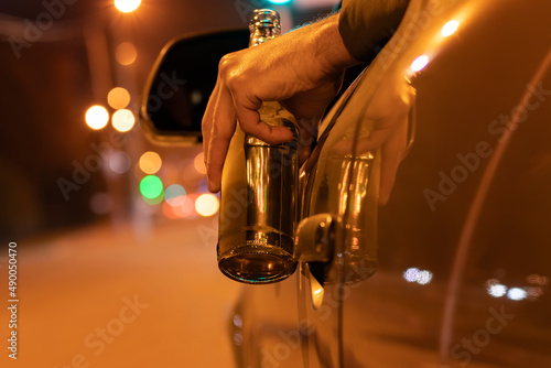 Sticker Drunk man driving a car with a bottle of beer at the night