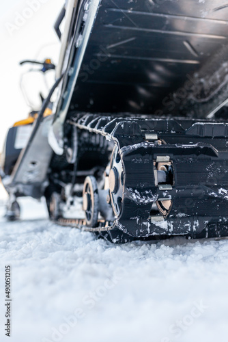The back of the snowmobile in winter. Riding in the snow on a snowmobile. Rear suspension of a snowmobile.Snowmobile in winter conditions. Extreme kind of winter outdoor sport. 