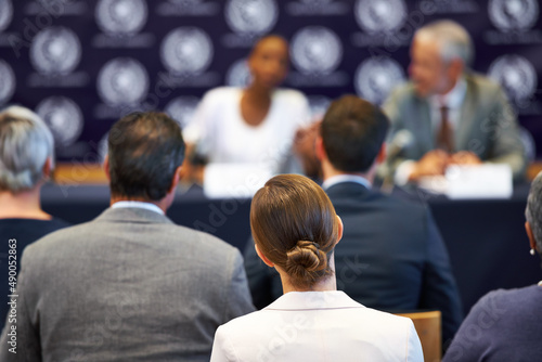 Giving their statement to the public. Shot of a group of businesspeople in a press conference. photo