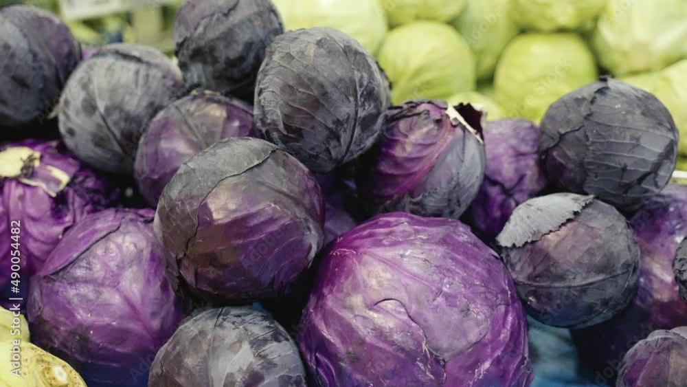 Close-up of fresh heads of red cabbage on display at the grocery store. Close-up of fresh heads of red cabbage on display at the grocery store.