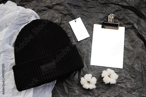 Beautiful trendy black knitted wool hat on background for design, mocap