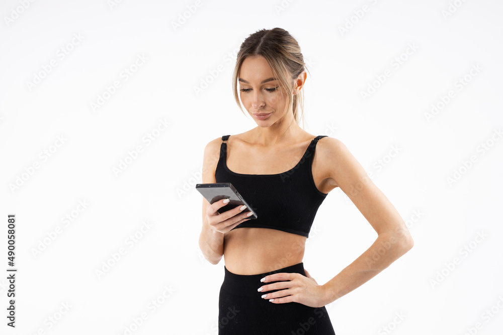 sporty young woman with mobile phone on white background
sporty young woman with mobile phone on white background