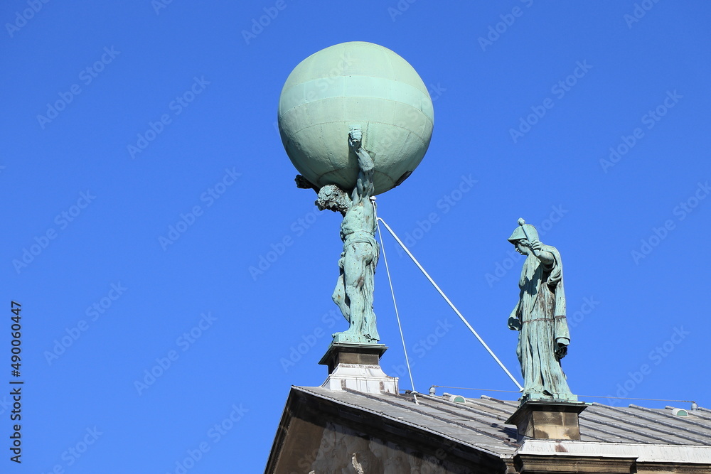 Amsterdam Royal Palace Roof Detail with Statue of Atlas against a Bright Blue Sky, Netherlands