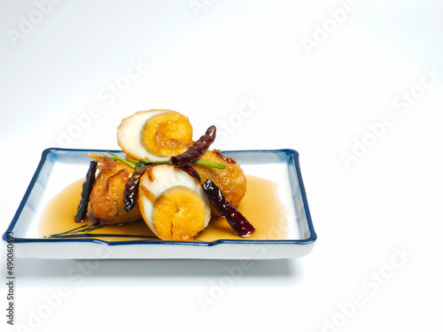 Fried Boiled Egg with Tamarind Sauce or Sweet and Sour Eggs on white background