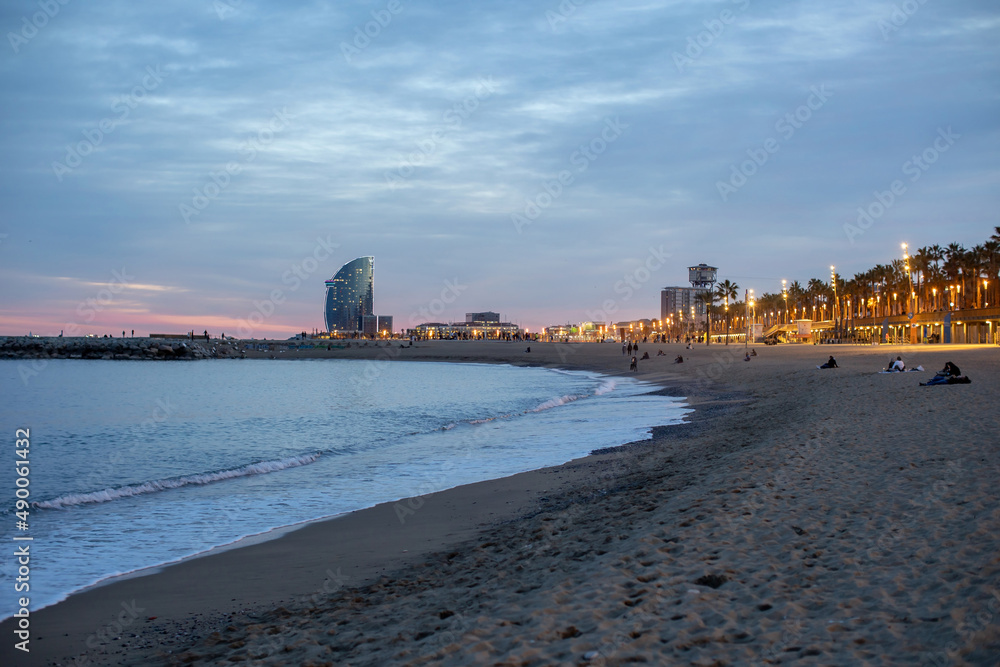 Beautiful landscape of the beach in Barcelona city on sunset