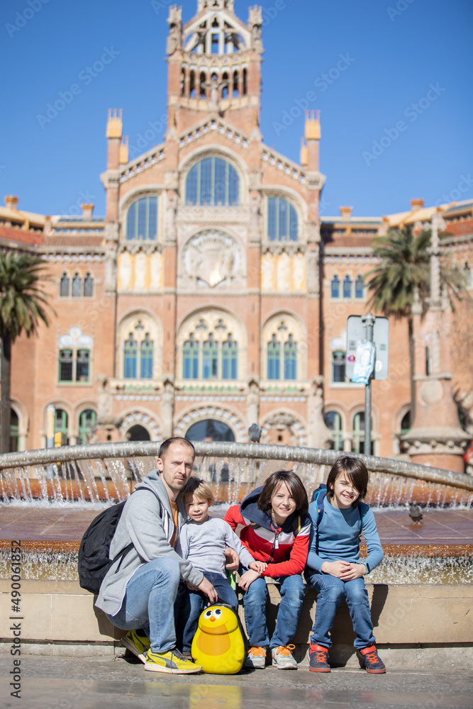 Cute little children tourists and father, admiring Barcelona city, family travel with kids