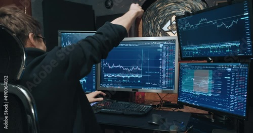 Man, freelance trader on the stock exchange, sees growth of quotations on chart and is very happy. Home environment. Concept of game on the stock exchange for trading stocks, futures and bonds