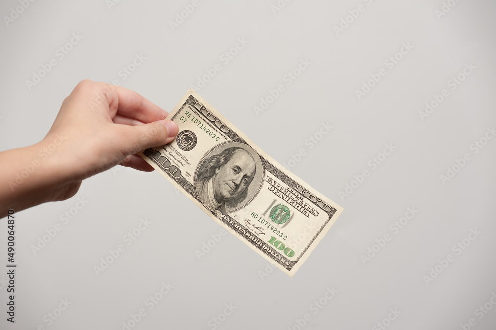 one hundred dollar bill in hands one hundred dollar bill in hands