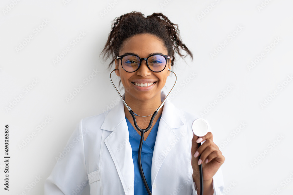 Portrait of black doctor smiling and showing stethoscope