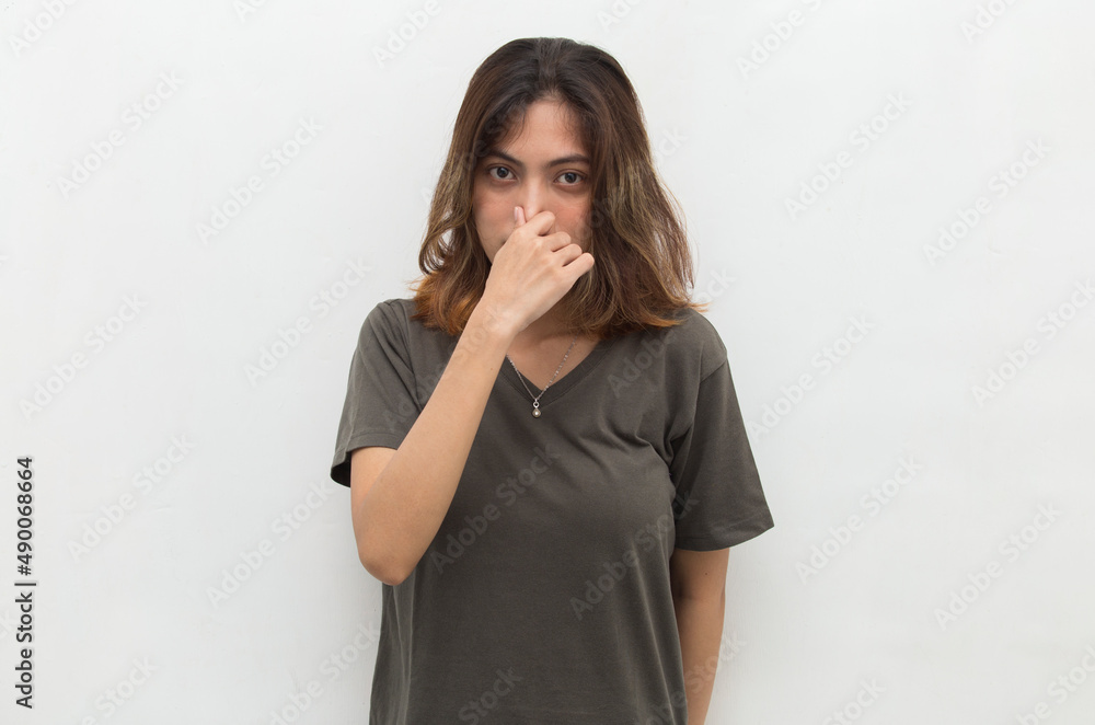 young asian beautiful woman holding her nose because of a bad smelling something
young asian beautiful woman holding her nose because of a bad smelling something
