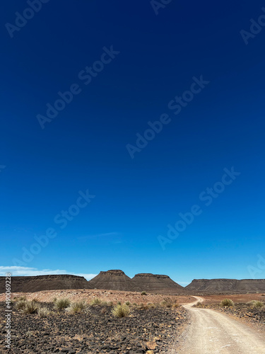 Gravel road in desert. Sandy landscape, nobody. Nature in Namibia, Africa