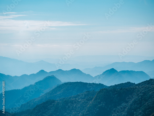 Layered mountain view of sunny day