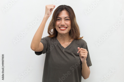 asian young woman happy and excited celebrating victory expressing big success on white background