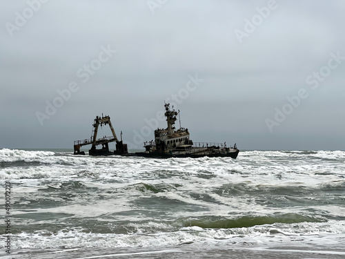 Sunken trawler, shipwreck. Old rusty metal ship Zeila at Skeleton Coast Namibia.