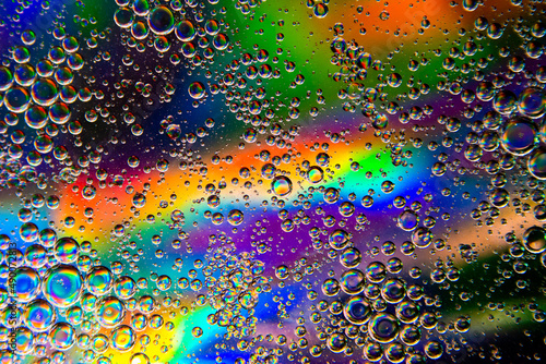 Bubbles in oil in water on a rainbow abstract macro background.