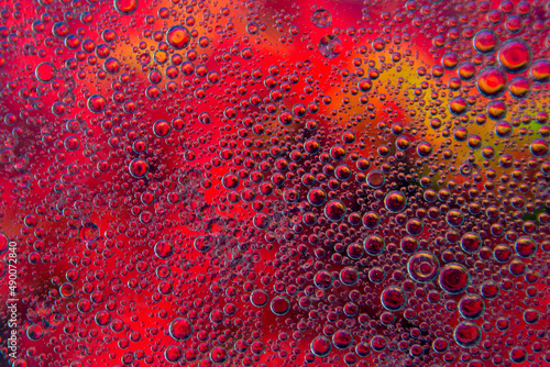 Bubbles in oil in water on pink, black and yellow colour abstract background