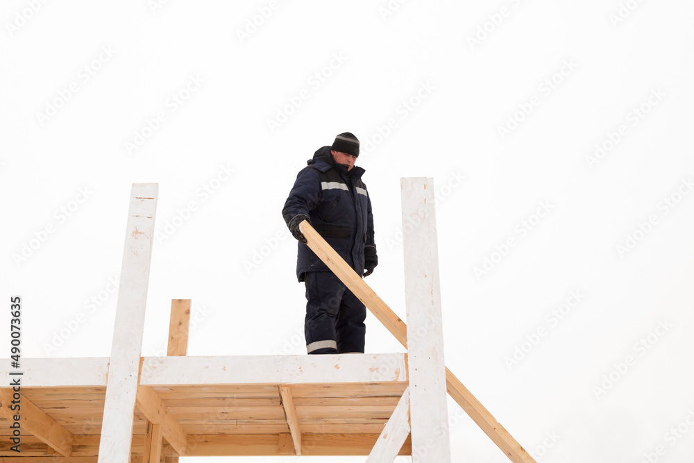 Worker assembling the frame of a wooden slide