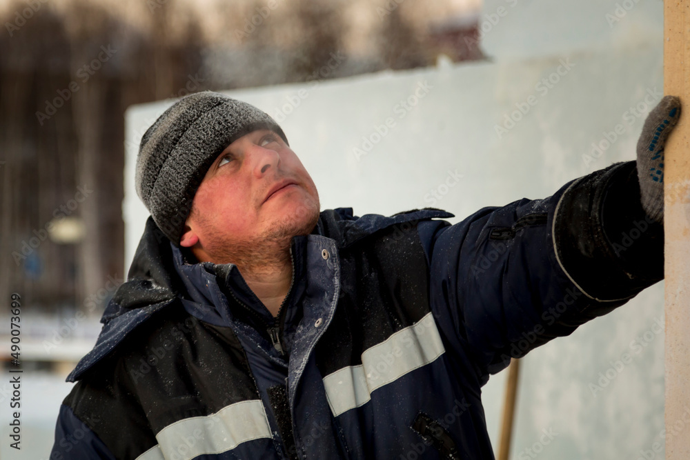 Portrait of an installer at the construction of an ice town