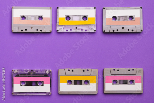 Collection of cassette tapes on purple background.