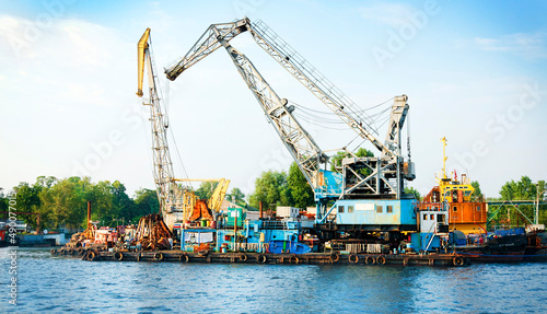 A scrap metal dump of old ships with cranes