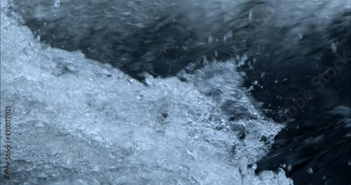 Close-up of water in slow motion on a river with single drops of water.