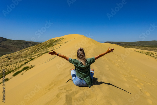 A girl on the sand dunes of Sarykum. The desert in Dagestan. Russia. 2021. © Виктория Балобанова