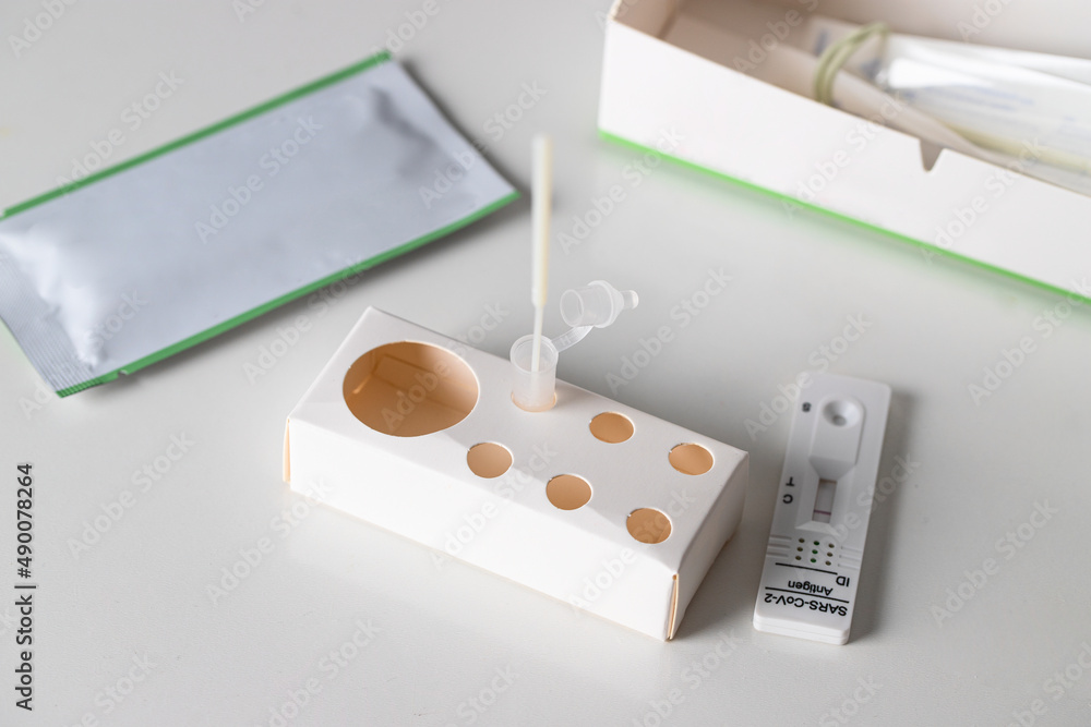 Covid-19 Test rapid antigen diagnostic test device with negative and positive result on blue background Covid-19 Test rapid antigen diagnostic test device with negative and positive result on blue background