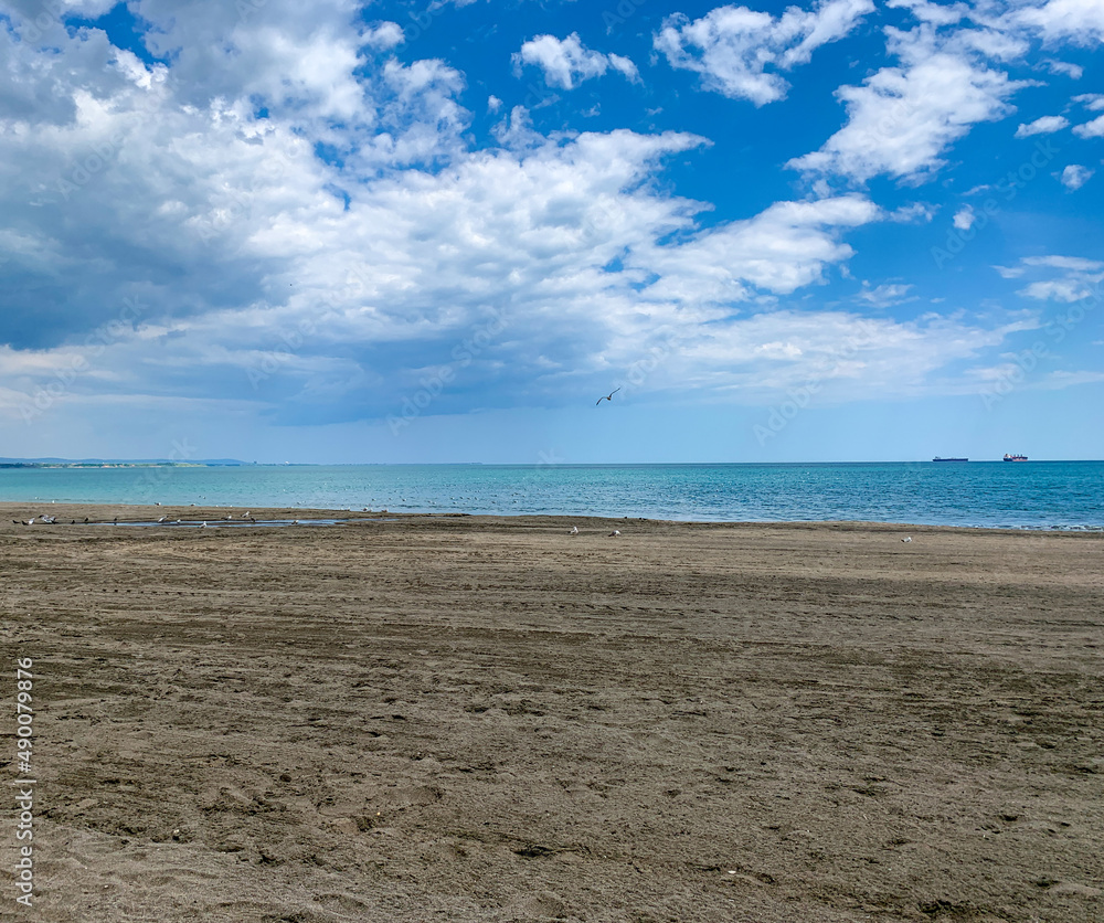 Lonely beach at Black sea coast with blue cloudy sky. Lonely beach at Black sea coast with blue cloudy sky.