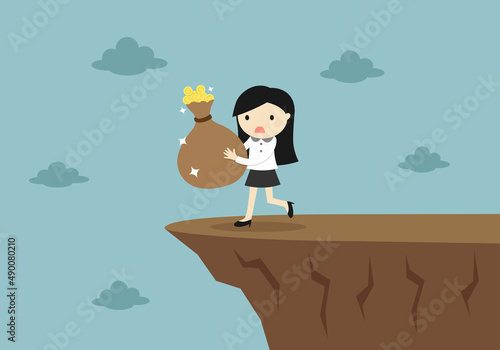 carelessly business woman is walking to the cliff while holding money.
