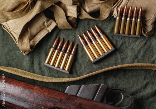 Military ammunition clips and bandoliers with rifle photo