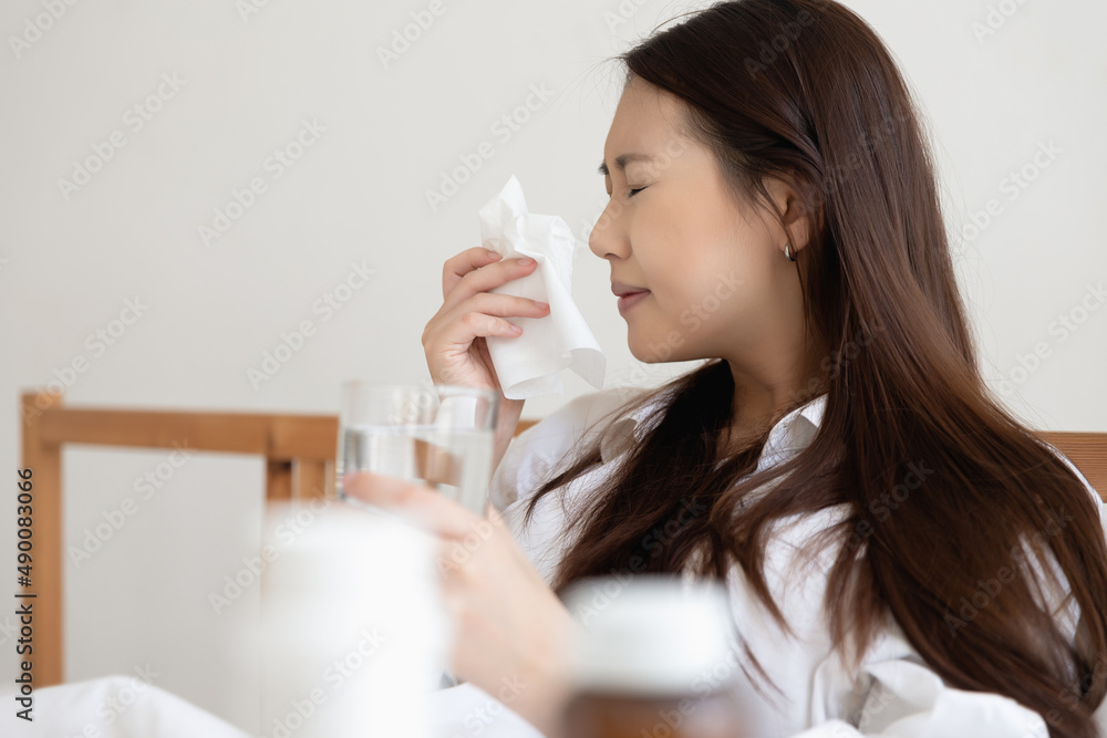 Asian woman feeling sick have a headache, coughing because of Coronavirus Covid-19. Protection and recovery from the illness quarantine at home, Stay at home. Asian woman feeling sick have a headache, coughing because of Coronavirus Covid-19. Protection and recovery from the illness quarantine at home, Stay at home.