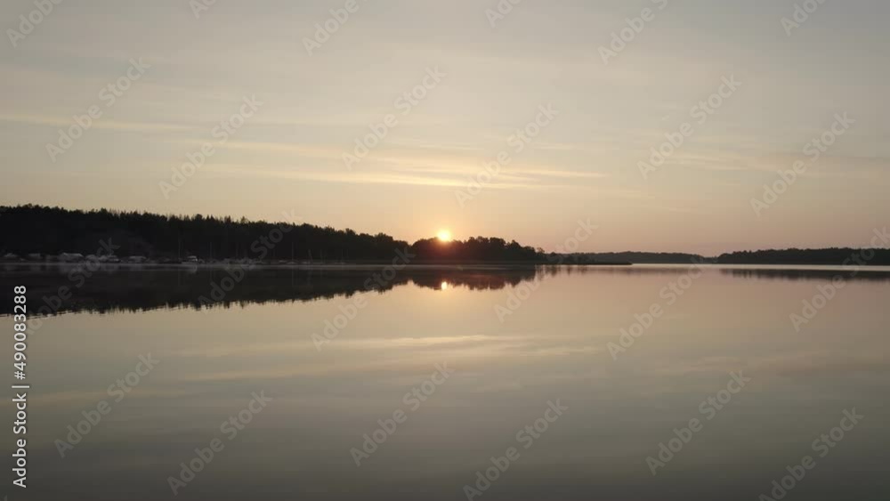 Sun setting down on the horizon water reflection, Sweden natural landscape Sun setting down on the horizon water reflection, Sweden natural landscape