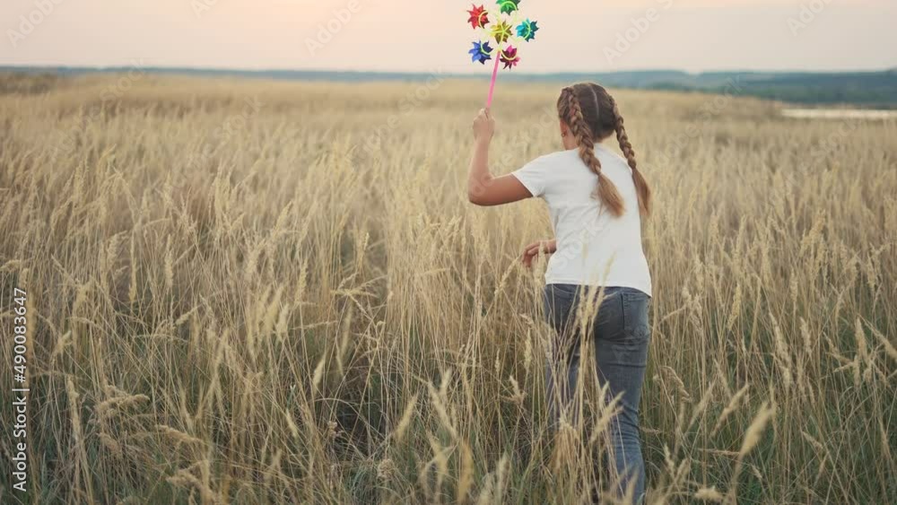 little girl run with a wind toy pinwheel. happy family kid dream concept. girl child run plays outdoors in the park. with a wind pinwheel toy. happy family childhood concept lifestyle little girl run with a wind toy pinwheel. happy family kid dream concept. girl child run plays outdoors in the park. with a wind pinwheel toy. happy family childhood concept lifestyle