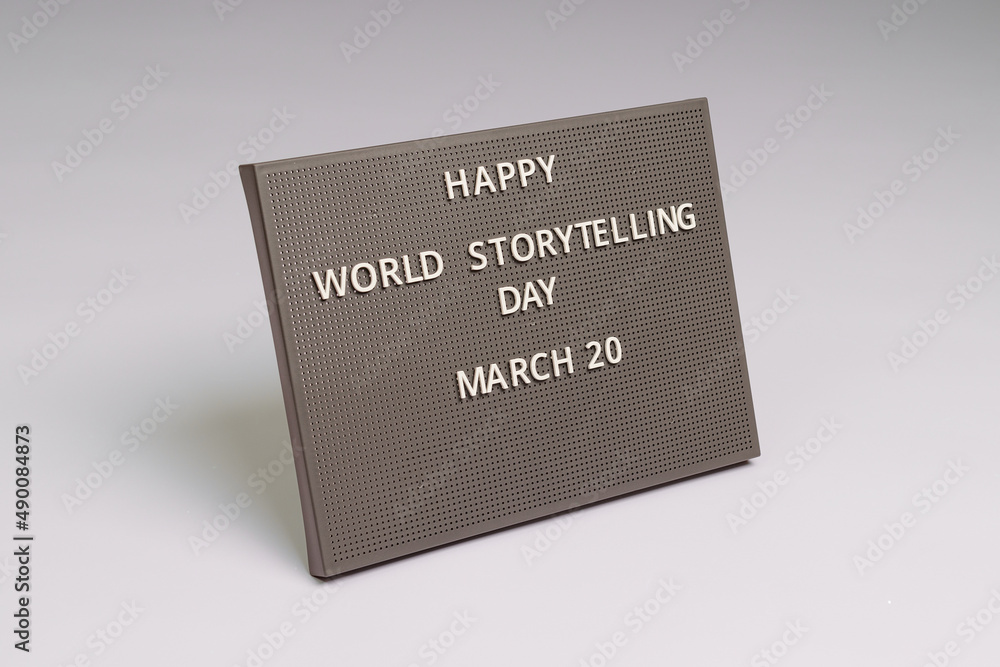 Happy World Storytelling Day 20 March lettering on gray chalkboard, white background
