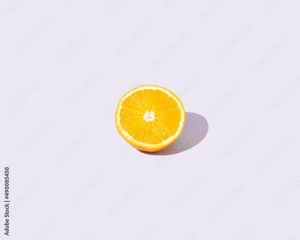Fresh orange on a pastel purple background. Minimal concept with isolated citrus fruit. Fresh orange on a pastel purple background. Minimal concept with isolated citrus fruit.