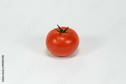 A perfect red tomato against a white background