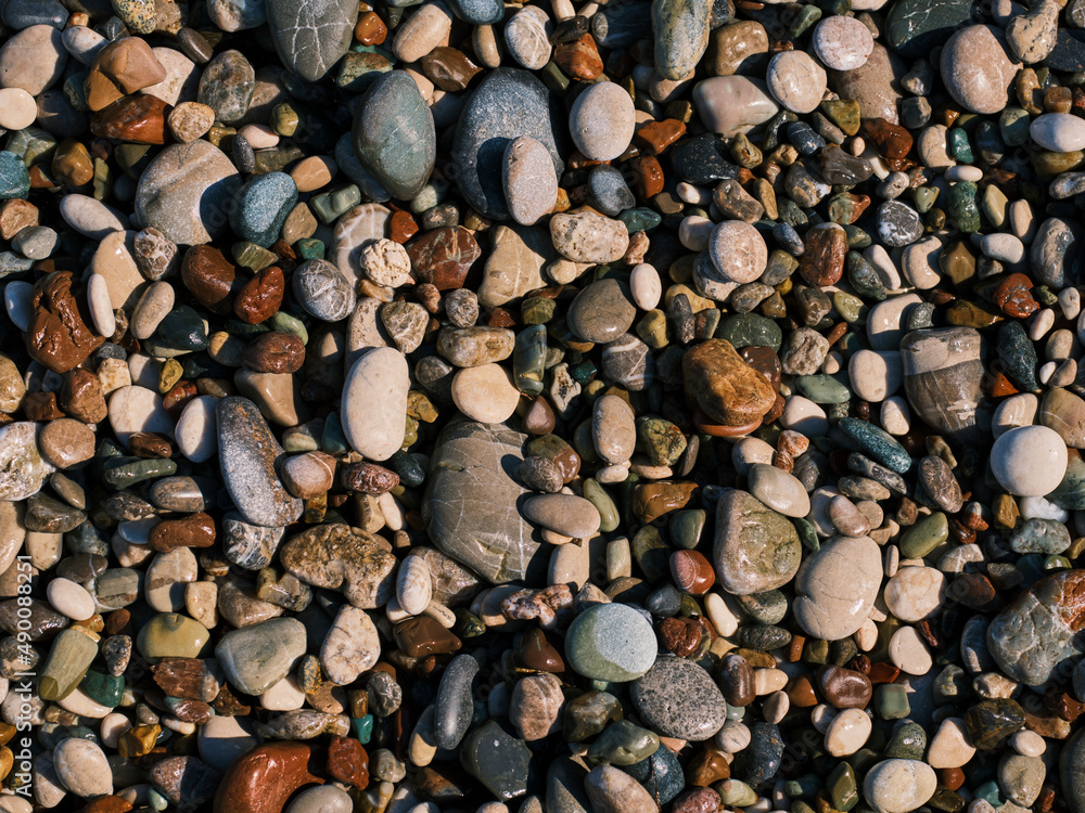 Naklejka premium colorful pebbles on the beach
