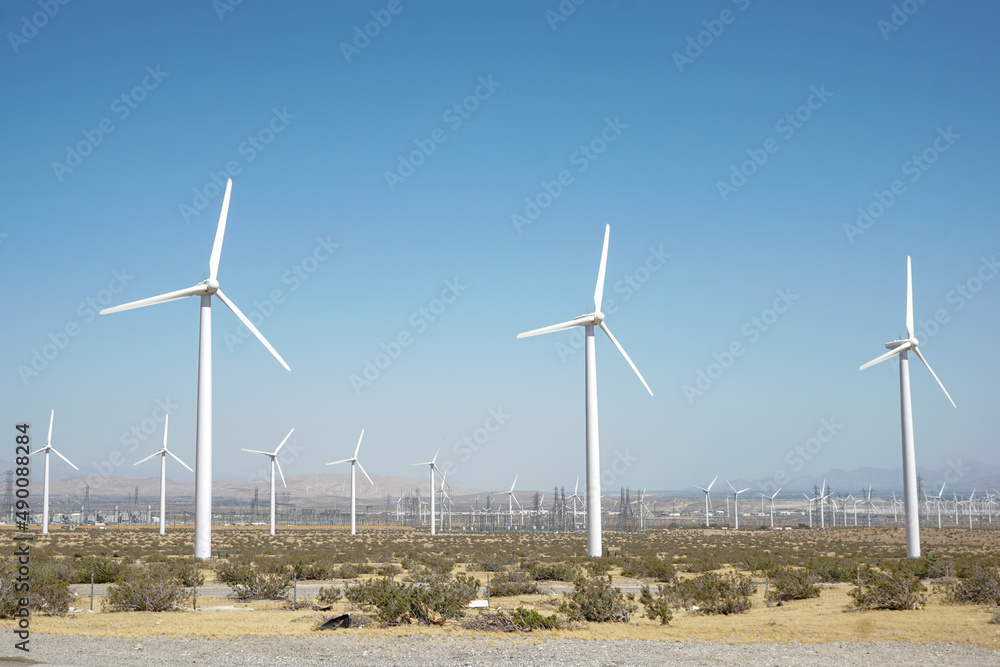 Wind turbines dot the landscape of a ecologically friendly wind farm. Wind turbines dot the landscape of a ecologically friendly wind farm.