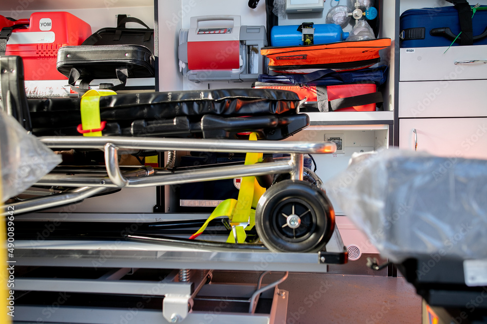 Interior of an ambulance car: stretcher, bags, other medical equipment