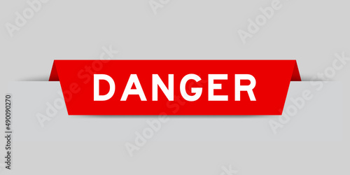 Red color inserted label with word danger on gray background