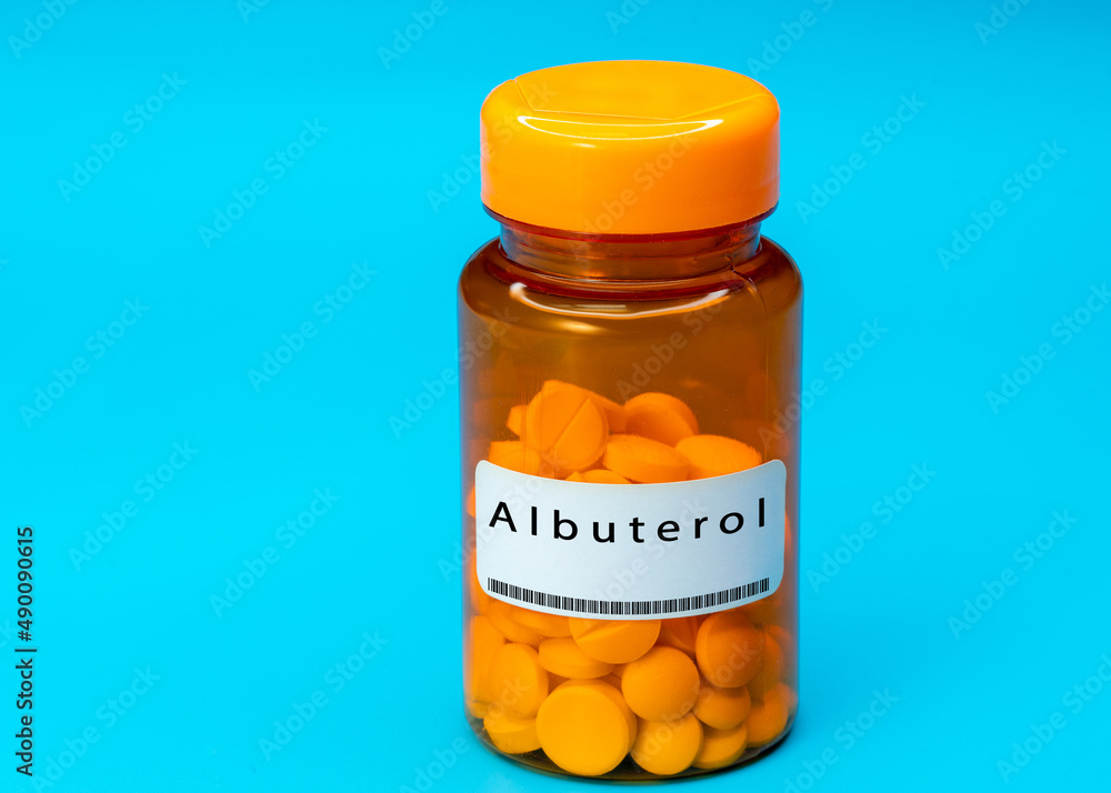 Medical vial with Albuterol pills. Medical pills in orange Plastic Prescription Medical vial with Albuterol pills. Medical pills in orange Plastic Prescription