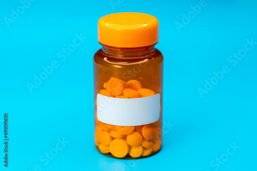  Medical vial with pills and empty label without text. Medical pills in orange Plastic Prescription. most popular medicine