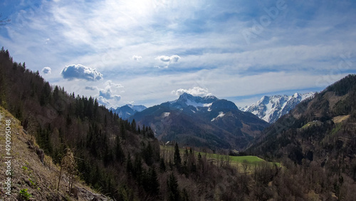 Scenic view of snow capped mountain peaks of Karawanks near Sinacher Gupf in Carinthia, Austria. Mount Wertatscha and Hochstuhl (Stol) is visible in early spring. Hills in Rosental on sunny day. Hike
