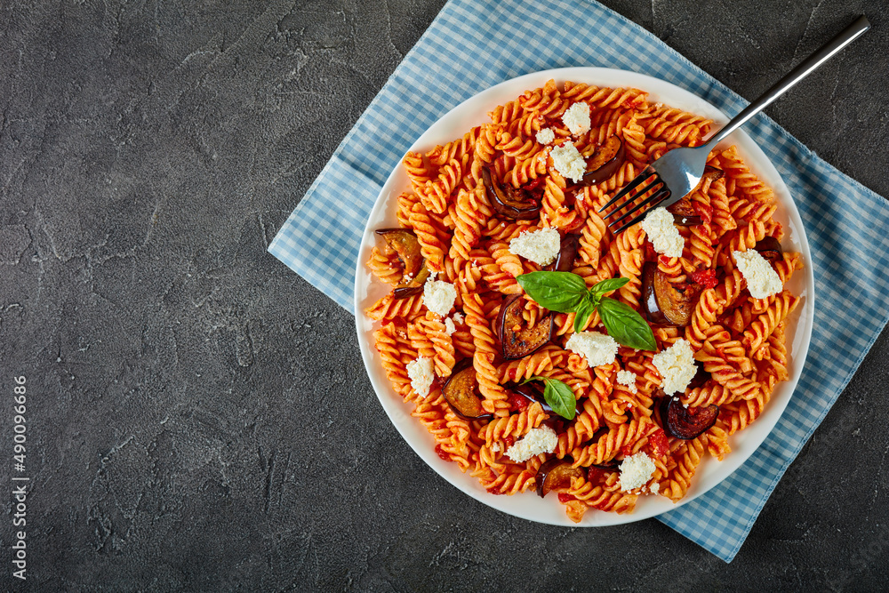 fusilli pasta with sauce, cheese and eggplants