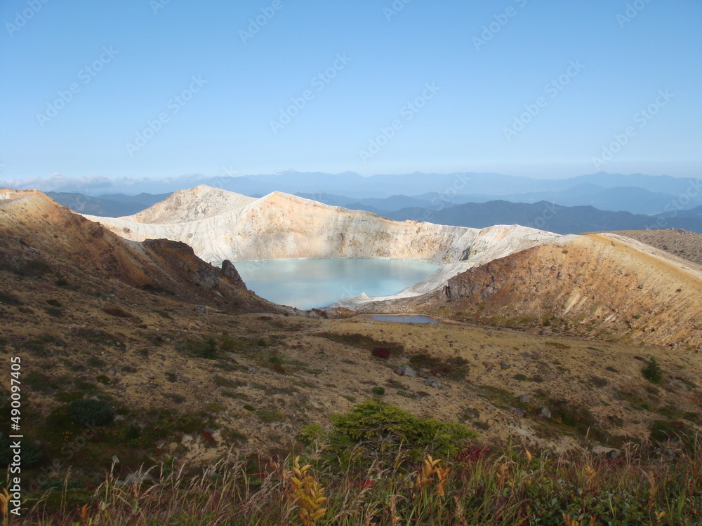 Beautiful toxic and acidic volcanic caldera lake with emerald green water in Yugama, Kusatsu, Gunma prefecture, Japan, Asia