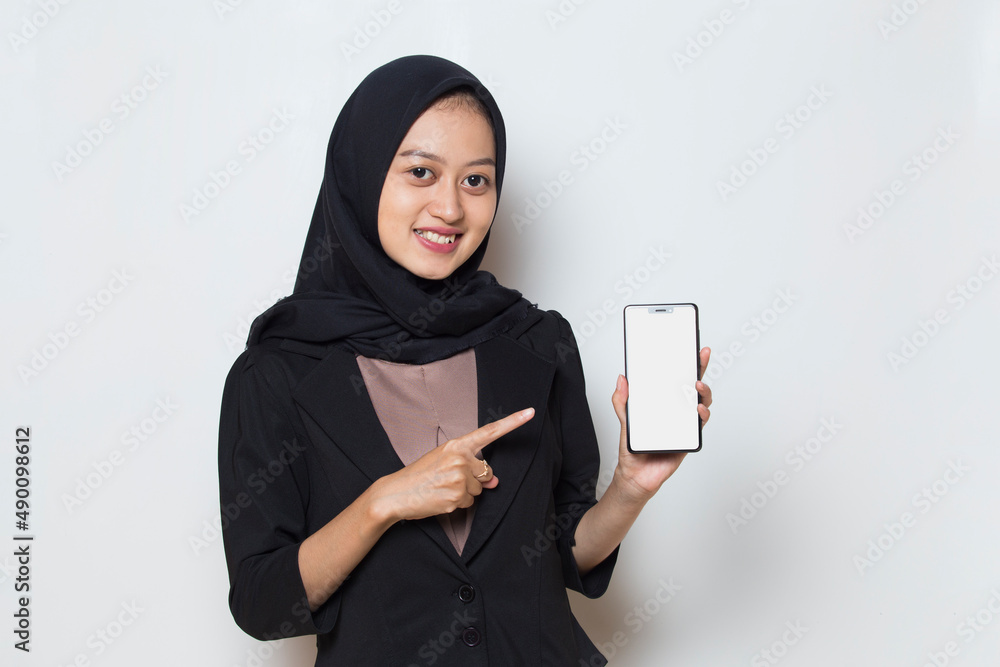 Happy Asian woman in hijab demonstrating mobile cell phone.
Happy Asian woman in hijab demonstrating mobile cell phone.