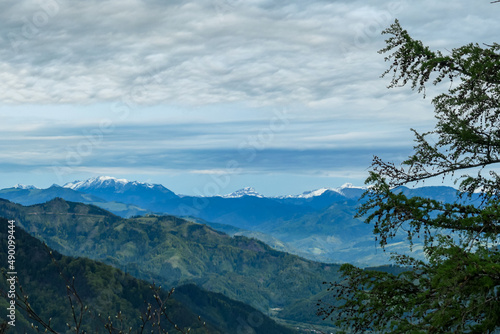 Panoramic view on the Eisenerzer Alps from below mount Roethelstein near Mixnitz in Styria  Austria. Snow capped mountain of the Ennstal Alps beyond the Grazer Bergland in Styria  Austria. Hochtor